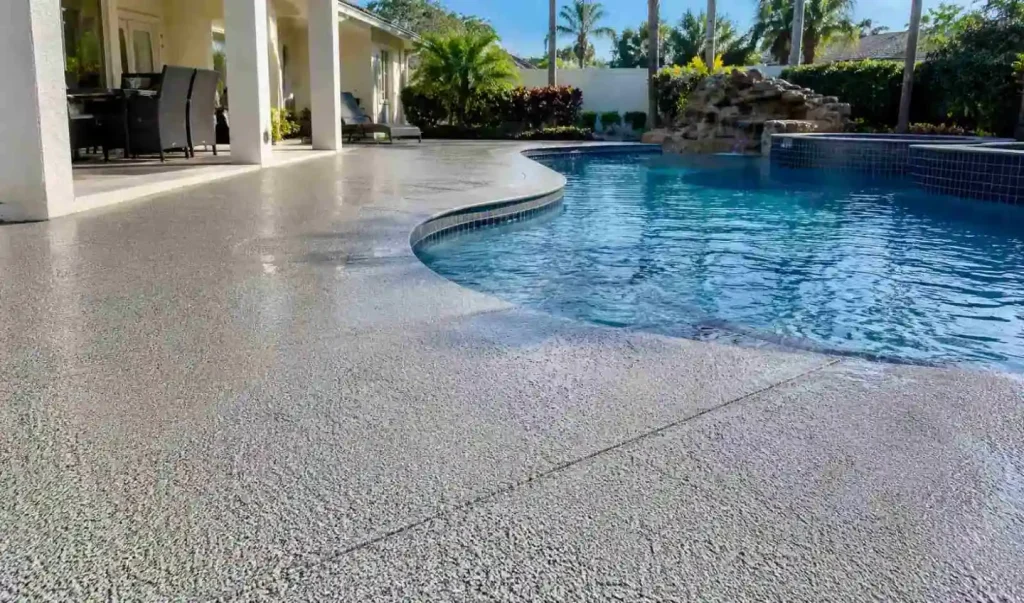 Slip-resistant polyaspartic concrete coating on a wet Tampa backyard pool deck